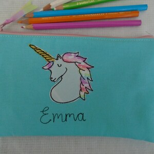 Unicorn motif personalised pencil case or cosmetic bag.  Pen or makeup pouch with choice of colour and coordinating lining.  Fastened with a zip and rainbow ribbon pull.  Ideal girls back to school gift