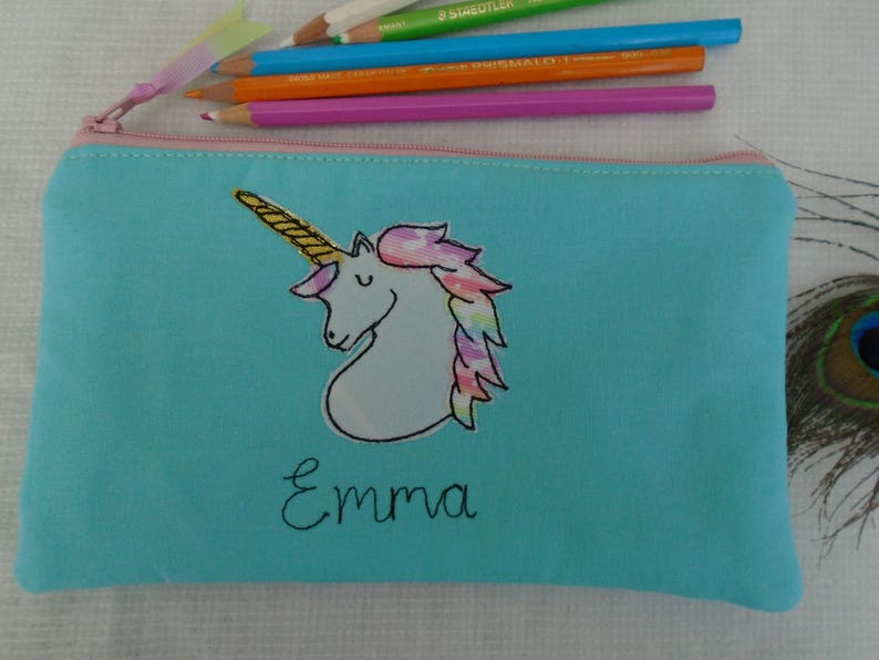 Unicorn motif personalised pencil case or cosmetic bag.  Pen or makeup pouch with choice of colour and coordinating lining.  Fastened with a zip and rainbow ribbon pull.  Ideal girls back to school gift