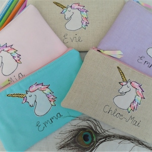 Unicorn motif personalised pencil case or cosmetic bag.  Pen or makeup pouch with choice of colour and coordinating lining.  Fastened with a zip and rainbow ribbon pull.  Ideal girls back to school gift