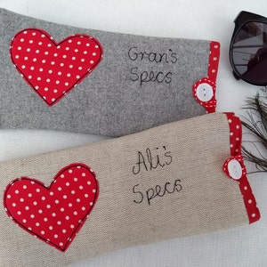 Personalised heart applique glasses case.  Spectacles or sunglasses pouch with choice of red dot or pink floral heart on linen or grey wool. coordinating ribbon and button fastening.  unique handmade customisable anniversary valentines gift