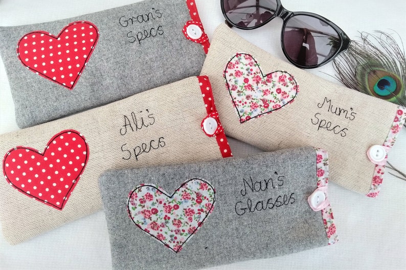 Personalised heart applique glasses case.  Spectacles or sunglasses pouch with choice of red dot or pink floral heart on linen or grey wool. coordinating ribbon and button fastening.  unique handmade customisable anniversary valentines gift