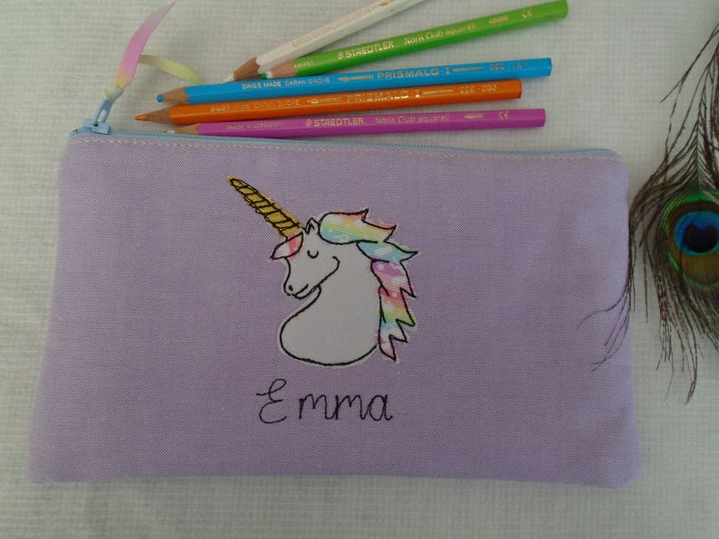 Unicorn motif personalised pencil case or cosmetic bag.  Pen or makeup pouch with choice of colour and coordinating lining.  Fastened with a zip and rainbow ribbon pull.  Ideal girls back to school gift