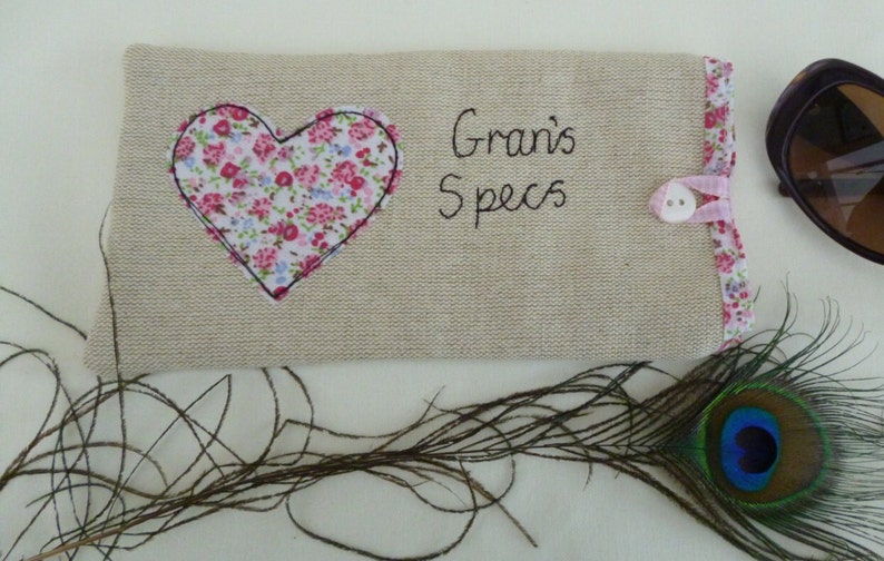Personalised heart applique glasses case.  Spectacles or sunglasses pouch with choice of red dot or pink floral heart on linen or grey wool. coordinating ribbon and button fastening.  unique handmade customisable anniversary valentines gift
