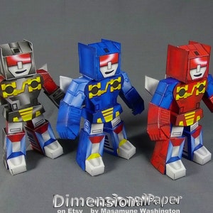May include: Three papercraft robots in red, blue, and black. Each robot has a yellow chest piece with a design of a circuit board. The robots are standing on a grey surface. DimensionalPaper on Etsy by Masamune Washington.