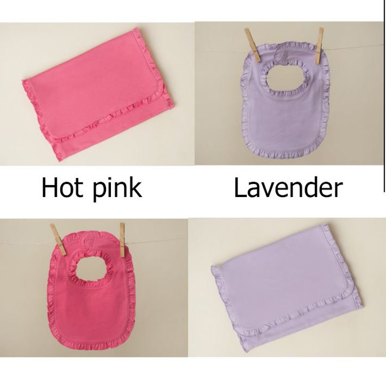 May include: Four baby bibs in two colors: hot pink and lavender. Two bibs are folded flat, and two bibs are hanging from clothespins. All bibs have a ruffled edge.