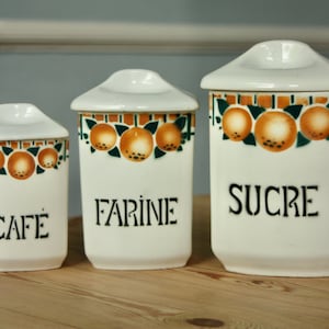 Three French ceramic canisters with Pochoir decoration.