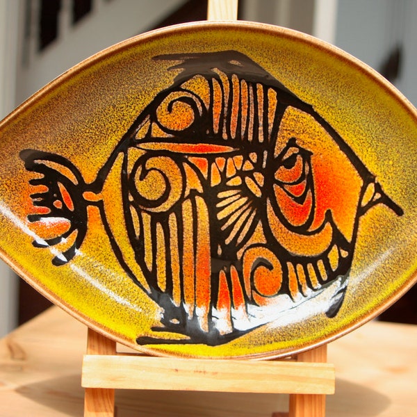 A Poole pottery dish with a stylised fish decoration from the Aegean series.
