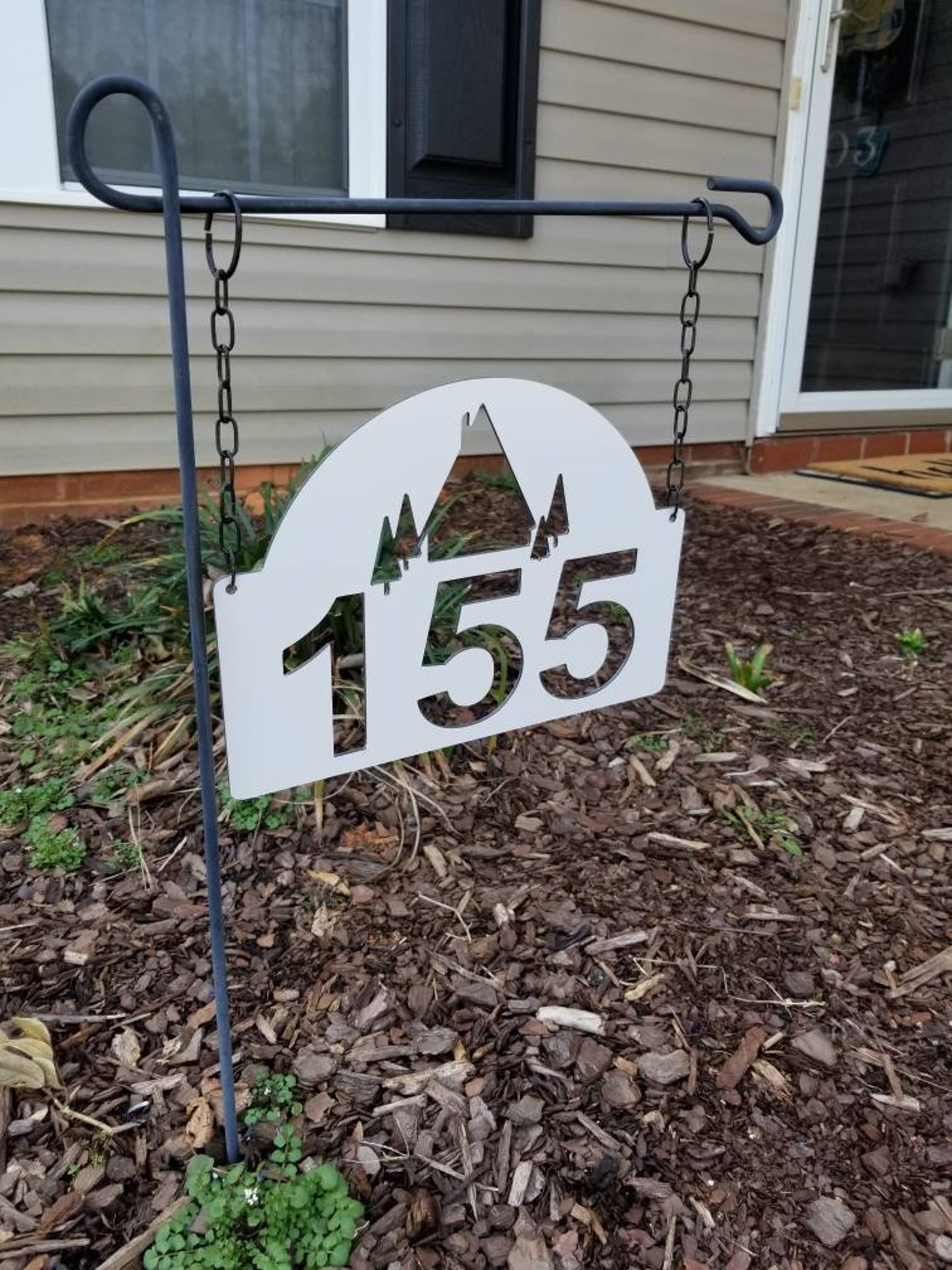 white lamp post with address sign