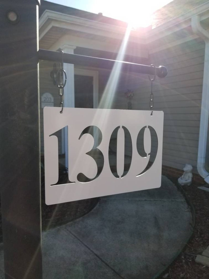 white lamp post with address sign