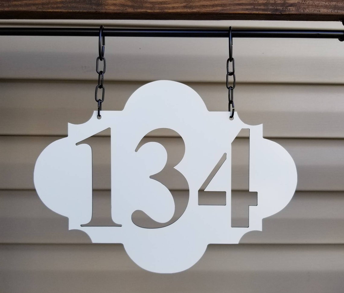 white lamp post with address sign