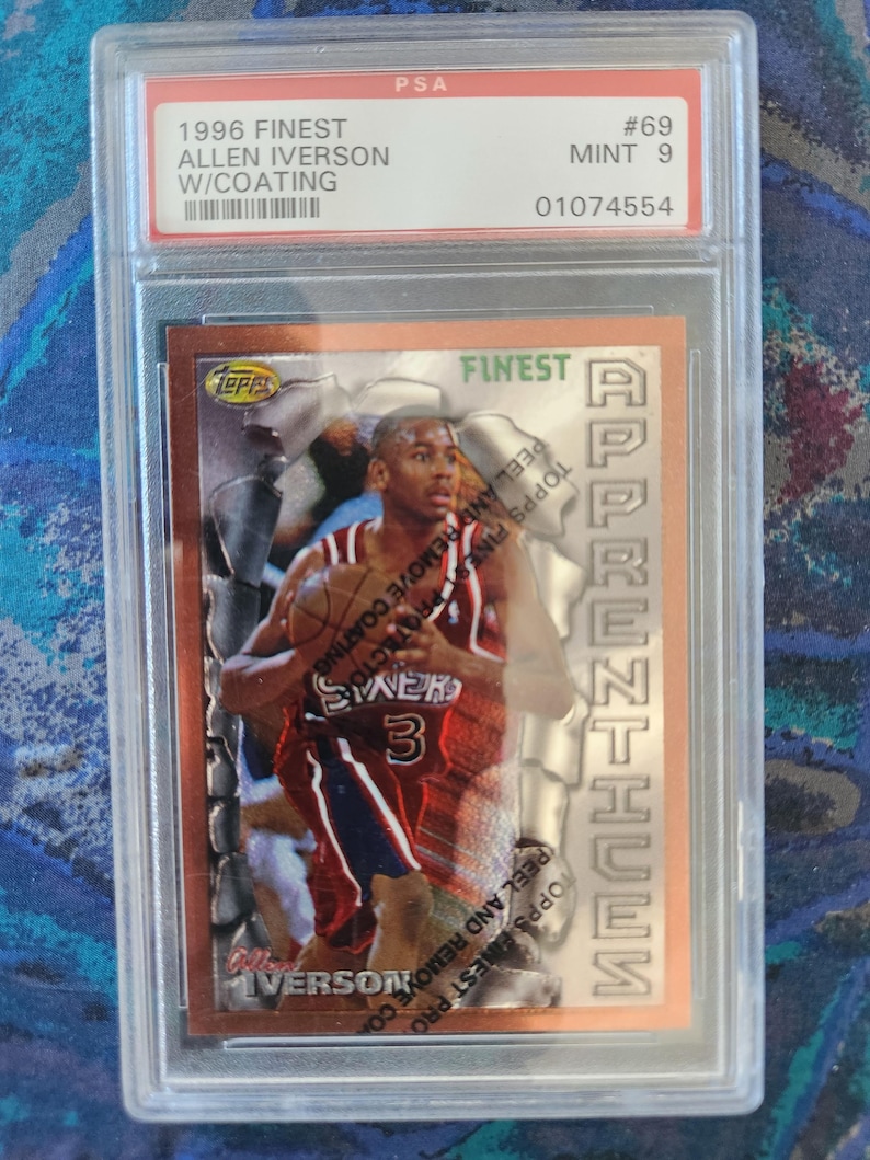 May include: A 1996 Finest Allen Iverson basketball card, graded Mint 9 by PSA, encased in a protective holder. The card features a photo of Allen Iverson in his Philadelphia 76ers uniform, with the word "Finest" visible.