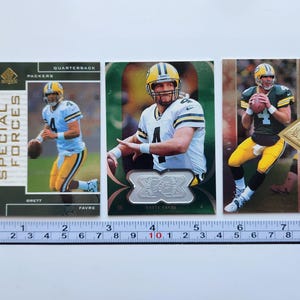 May include: A set of three ceramic mugs with a speckled, matte finish. The mugs are in shades of cream, light gray, and dark gray. Each mug has a simple, minimalist design and a rounded handle.