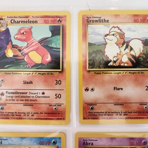 May include: Two vintage Pok&eacute;mon trading cards. One features Charmeleon, a red and yellow flame Pok&eacute;mon, with the text "Flame Pok&eacute;mon. Length: 3' 7", Weight: 42 lbs." The other card shows Growlithe, a puppy Pok&eacute;mon, with the text "Puppy Pok&eacute;mon. Length: 2' 4", Weight: 42 lbs."