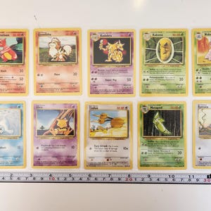 May include: A collection of ten Pok&eacute;mon trading cards. The cards feature various Pok&eacute;mon characters, including Charmeleon, Growlithe, Kadabra, Kakuna, Nidorino, Seel, Abra, Doduo, Metapod, and Rattata. Each card has a unique illustration and text.