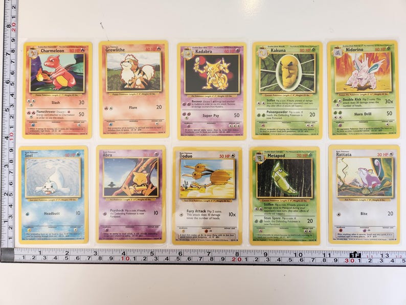 May include: A collection of ten Pok&eacute;mon trading cards. The cards feature various Pok&eacute;mon characters, including Charmeleon, Growlithe, Kadabra, Kakuna, Nidorino, Seel, Abra, Doduo, Metapod, and Rattata. Each card has a unique illustration and text.