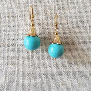 Turquoise ball gold plated earrings.