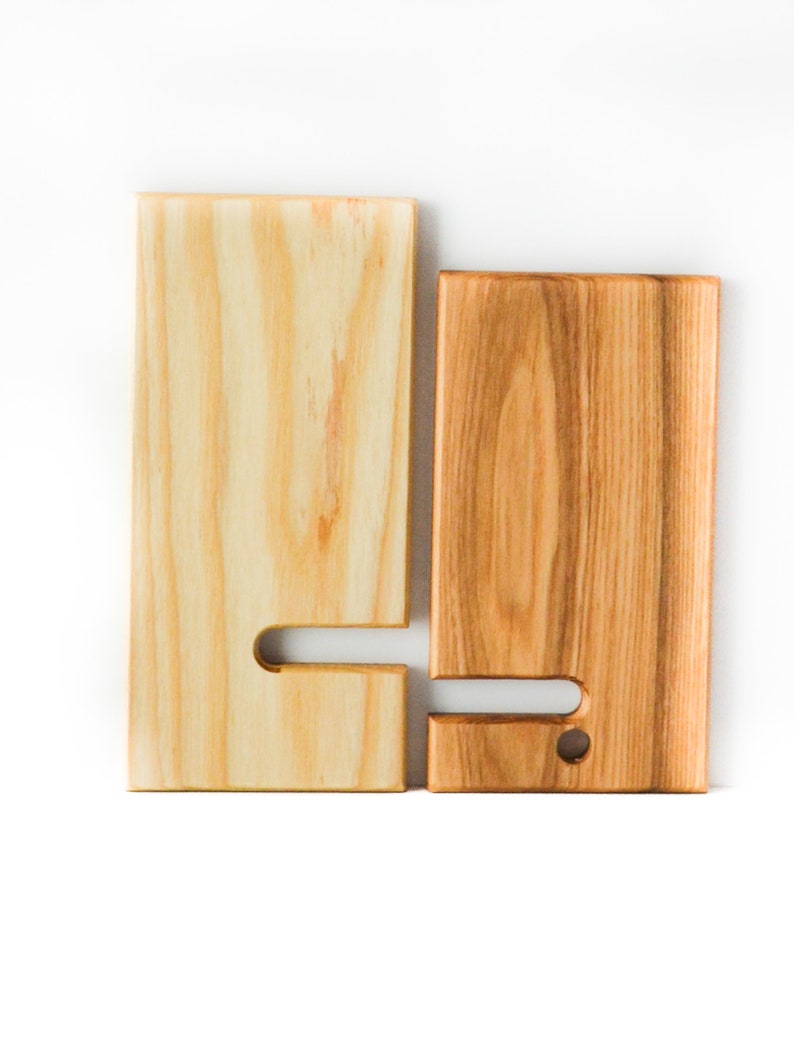 Two Tone Ash wooden cell phone stand. The two pieces are separated to show how they fit together and how the stand easily collapses for easy travel or carrying.