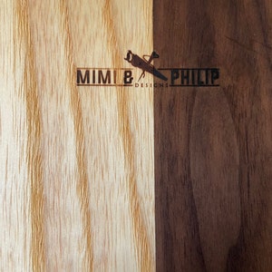 Two tone (light on left; dark on right) showing the Mimi and Philip logo wood burn on the back of all cutting boards.