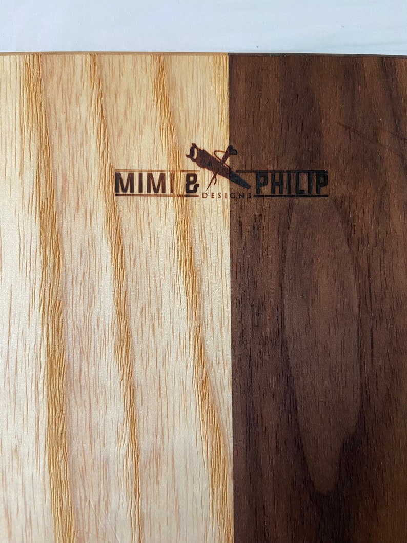 Two tone (light on left; dark on right) showing the Mimi and Philip logo wood burn on the back of all cutting boards.