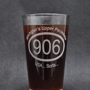 The &quot;Michigan&#39;s Upper Peninsula (906 Area Code Oval) USA… Sorta…&quot; Etched Pint Glass
