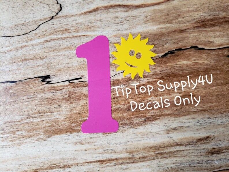May include: Pink number one decal with a yellow smiling sun decal. Tip Top Supply4U Decals Only.