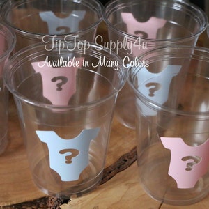 May include: Clear plastic cups with blue and pink baby onesie stickers with a question mark on each. The text "Tip Top Supply4u" and "Available in Many Colors" is printed on the cups.