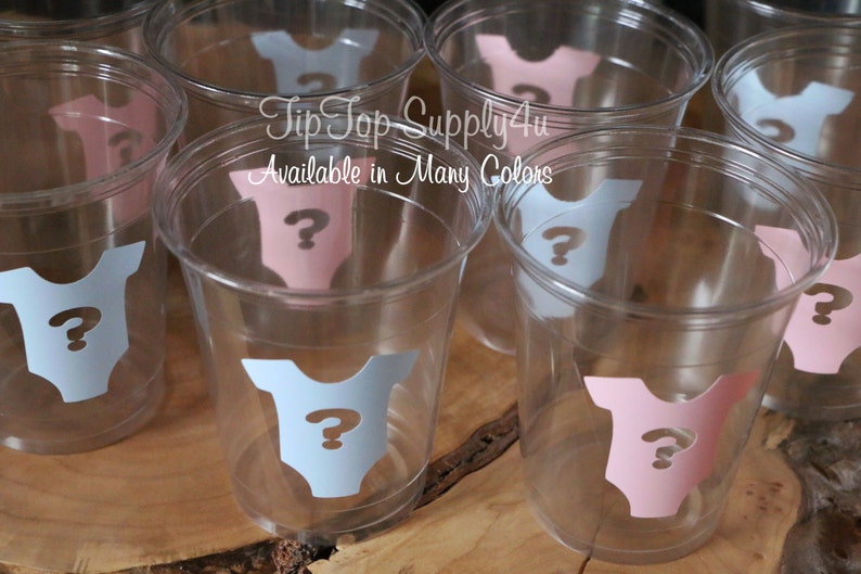 May include: Clear plastic cups with blue and pink baby onesie stickers with a question mark on each. The text "Tip Top Supply4u" and "Available in Many Colors" is printed on the cups.