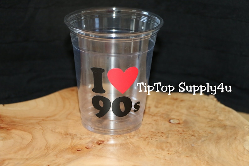 May include: Clear plastic cup with a black and red sticker that says "I love 90s" with a red heart.