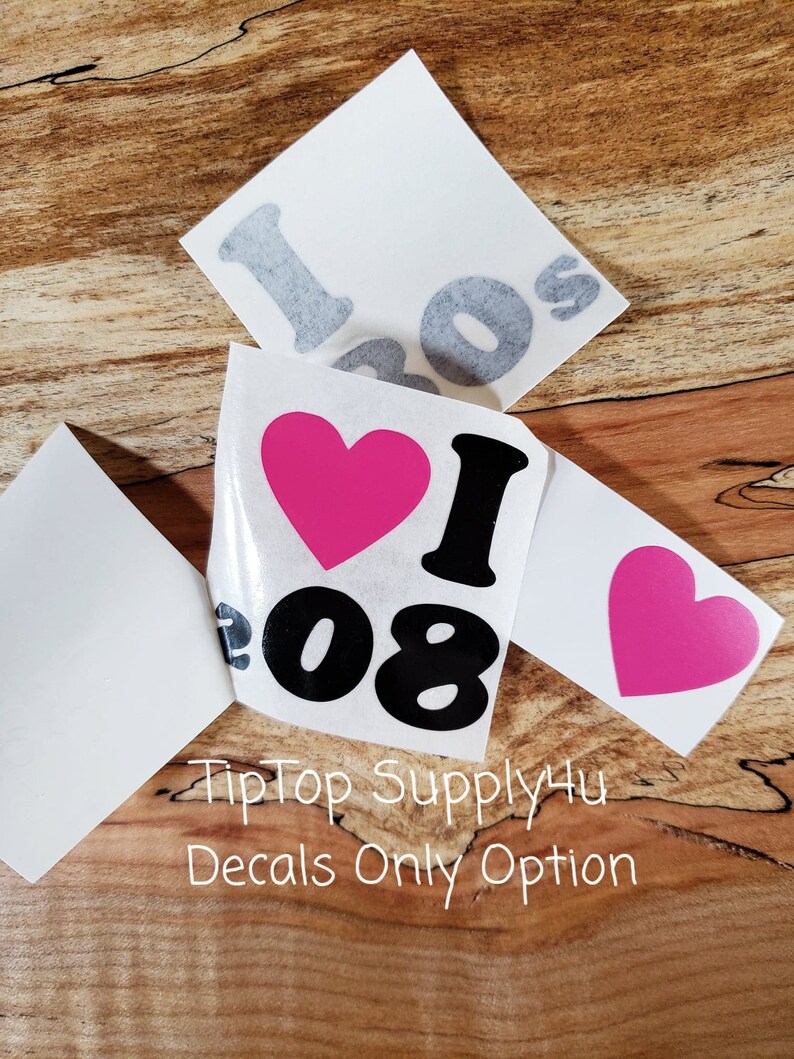 May include: White vinyl decals with the text "I 08" and a pink heart. The decals are shown on a wooden surface. The text "TipTop Supply4u Decals Only Option" is also visible.