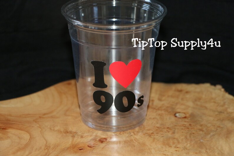 May include: Clear plastic cup with a black and red sticker that says "I love 90's".