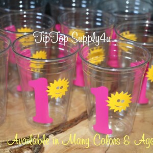 May include: Clear plastic cups with a pink number one and a yellow sun with a smiley face. The text "Tip Top Supply4u" is visible in the image.