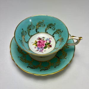Paragon Turquoise And Gild Tea Cup & Saucer, With Flowers