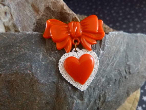 1950s Celluloid Plastic Red Valentine Heart Dangling from Bow Vintage Pin | Book Piece
