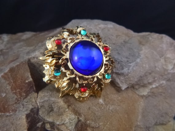 Regal Filigree Domed Vintage Circle Brooch | obalt Blue Glass Stone Surrounded by Floral Motif with Center Red and Green Glass Highlights