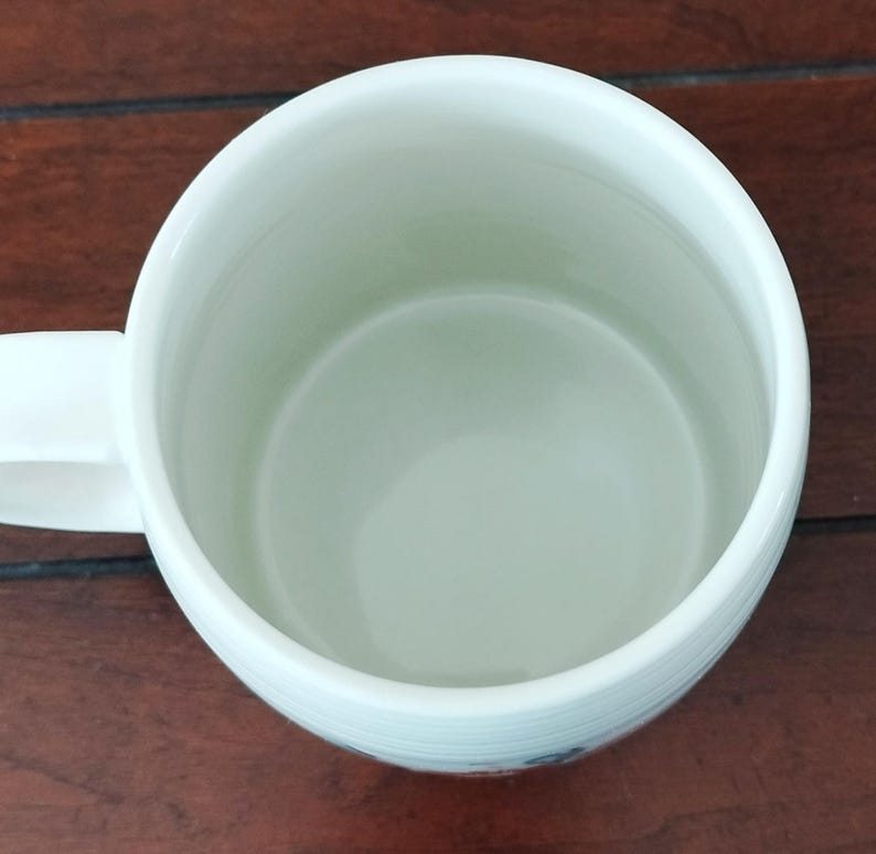May include: A set of three ceramic mugs with a speckled, matte finish. The mugs are in shades of cream, light brown, and dark brown. Each mug has a simple, minimalist design and a rounded handle. Perfect for coffee or tea.