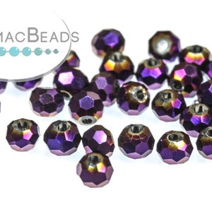 May include: A group of purple iridescent glass beads with a faceted design. The beads have a hole in the center for stringing.