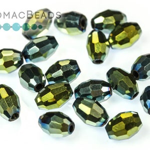 May include: A group of 15 faceted oval glass beads in a dark green and gold iridescent color. The beads are approximately 10mm long and 6mm wide.