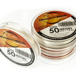 May include: White DragonThread beading thread, 50 meters, 0.005 inches in diameter.  The spool is labeled "Strongest beading thread on the market, so your designs will last longer!"