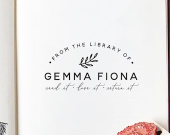 May include: A black and white stamp with the text "• FROM THE LIBRARY OF. GEMMA FIONA read it. love it. return it" and a small branch with leaves.