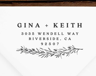 May include: A white envelope with a black return address stamp that reads "GINA + KEITH 3035 WENDELL WAY RIVERSIDE, CA 92507" with a decorative floral design.