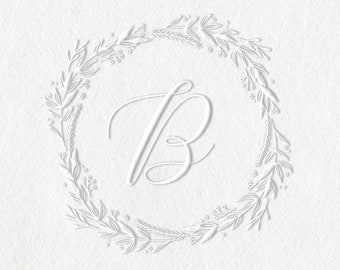 May include: A silver self-inking stamp with a black handle. The stamp features a wreath design with the letter "B" in the center. The stamp is labeled "Shiny" and "Model-EM".