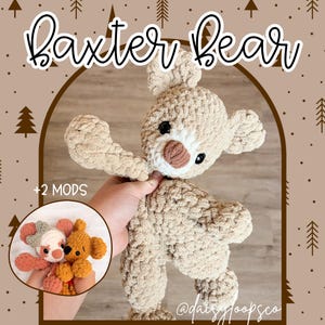 May include: A handmade, beige crocheted bear named "Baxter Bear" with a brown nose and black eyes. The bear is held up by a hand. A smaller crocheted bear is in a circle in the lower left corner. The text "+2 MODS" is above the circle.