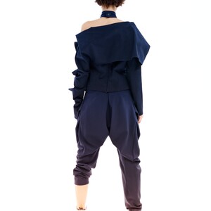May include: A navy blue off-the-shoulder top with long sleeves and a matching pair of pants. The outfit has a relaxed, casual fit.