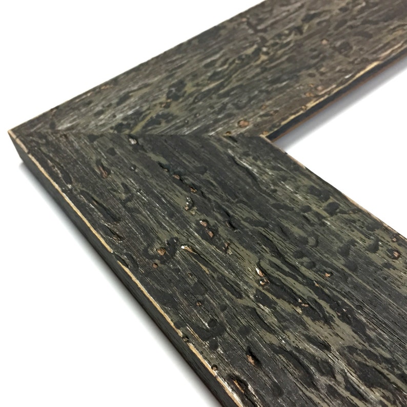 May include: Close-up of a dark grey wood picture frame with a distressed finish. The frame has a slightly raised edge and a smooth, even surface.
