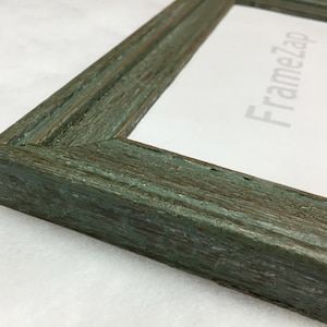 May include: A green wood picture frame with a distressed finish. The frame has a simple, rectangular design.