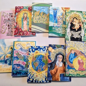 May include: A set of 10 colorful cards with watercolor illustrations and inspirational quotes. The cards feature a variety of subjects, including religious figures, nature scenes, and abstract designs. Each card has a different quote and a unique design.
