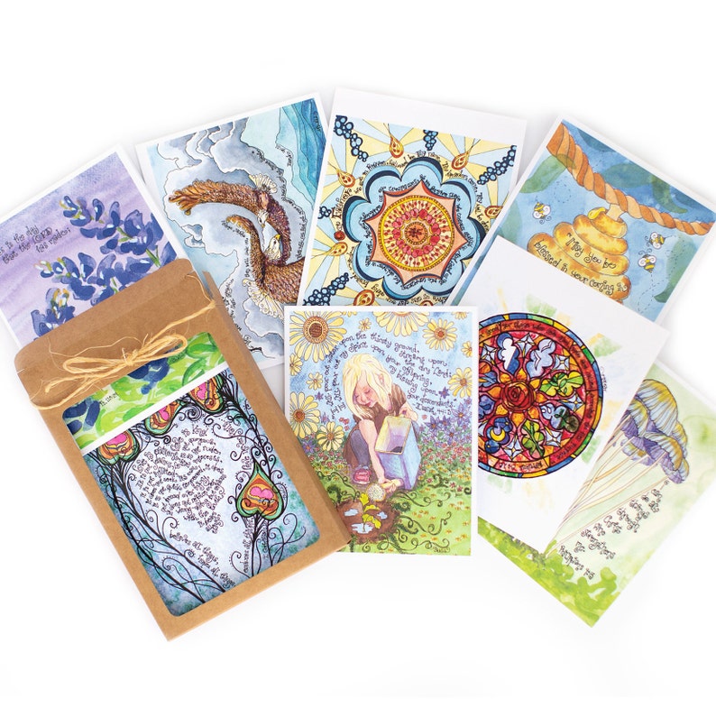 May include: A selection of watercolour art cards with diverse designs, such as floral patterns, celestial themes, and inspirational quotes. The cards are packaged in a brown paper sleeve tied with twine, displaying a preview of the artwork.
