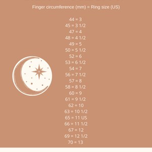 May include: A chart with a crescent moon and star graphic shows ring sizes in US sizes and corresponding finger circumference in millimeters. The text reads "RING SIZING" and "Finger circumference (mm) = Ring size (US)". The chart lists ring sizes from 3 to 13, with corresponding finger circumference measurements in millimeters.