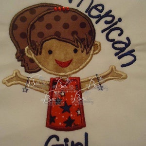 May include: Embroidered design of a girl with brown hair and a red, white, and blue dress with stars. The text "American Girl" is above the girl.