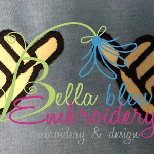 May include: Two black and yellow embroidered thumbs up hand gestures on a blue background. The text "Bella Bleu Embroidery" is below the thumbs up.